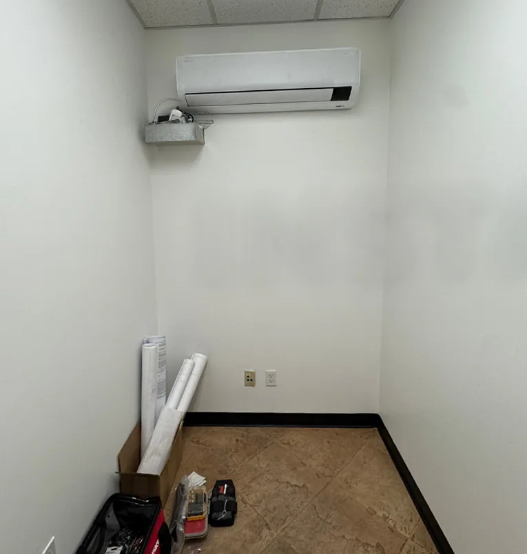 Before: an empty equipment room with a wall-mounted AC unit and bare walls